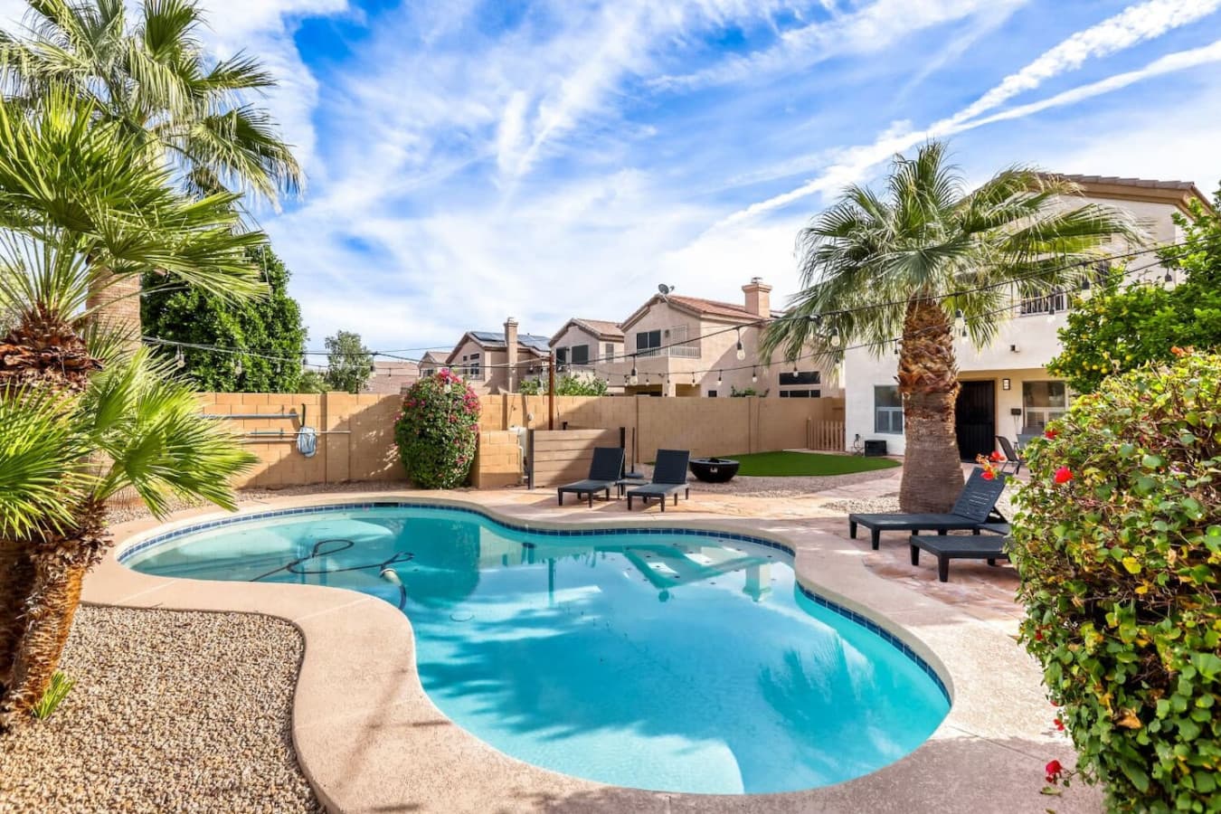 Private backyard oasis with a sparkling pool and lounge seating for sunny afternoons.
