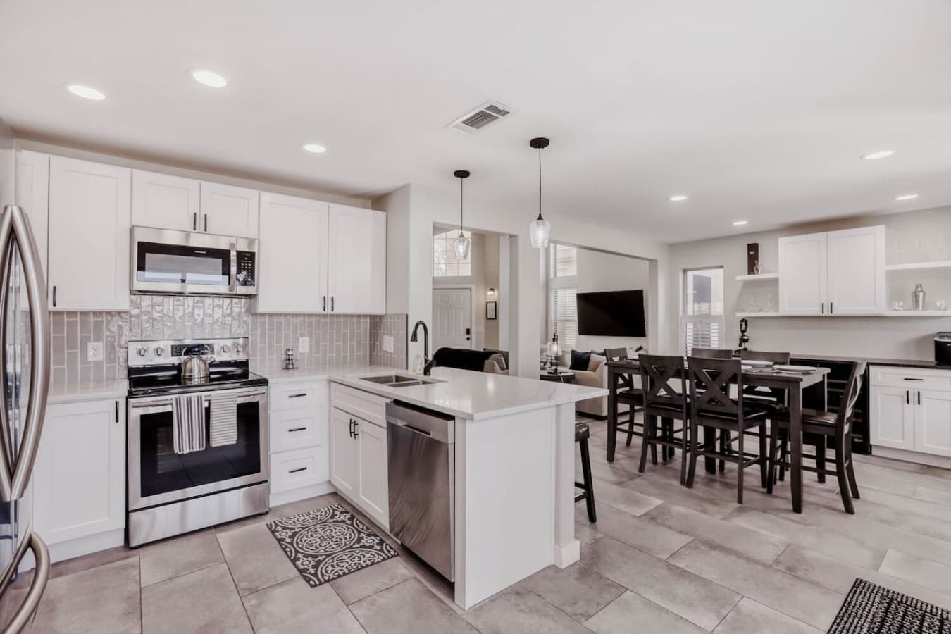 Central kitchen with a large island, modern appliances, and seating for casual meals.