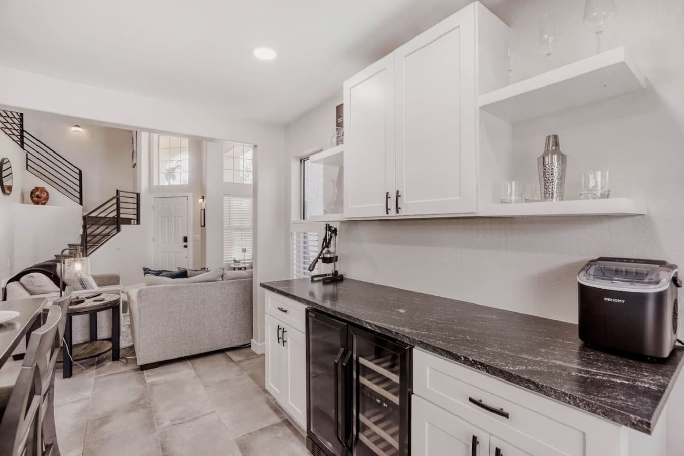 Convenient beverage station with wine fridge and additional prep space.
