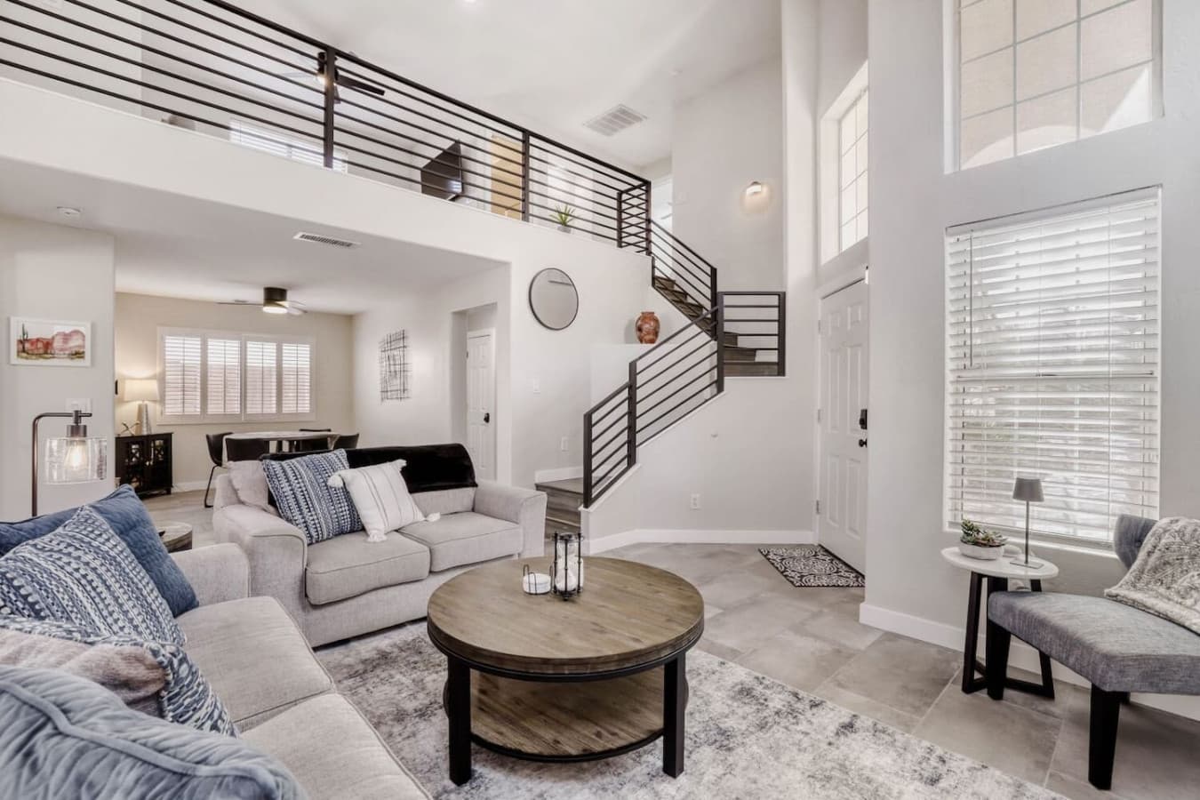 Inviting main living room featuring high ceilings and modern rail details.