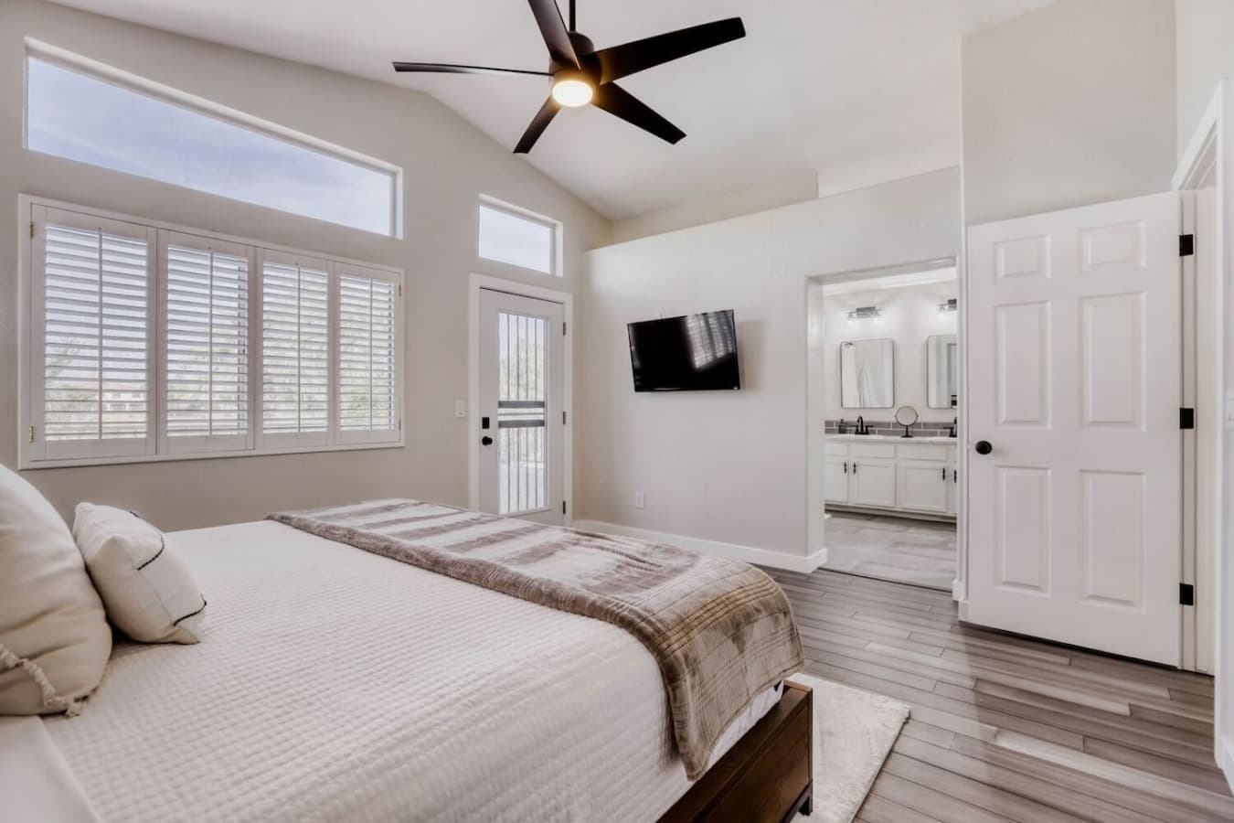 Serene bedroom retreat with a comfortable bed and abundant natural light.
