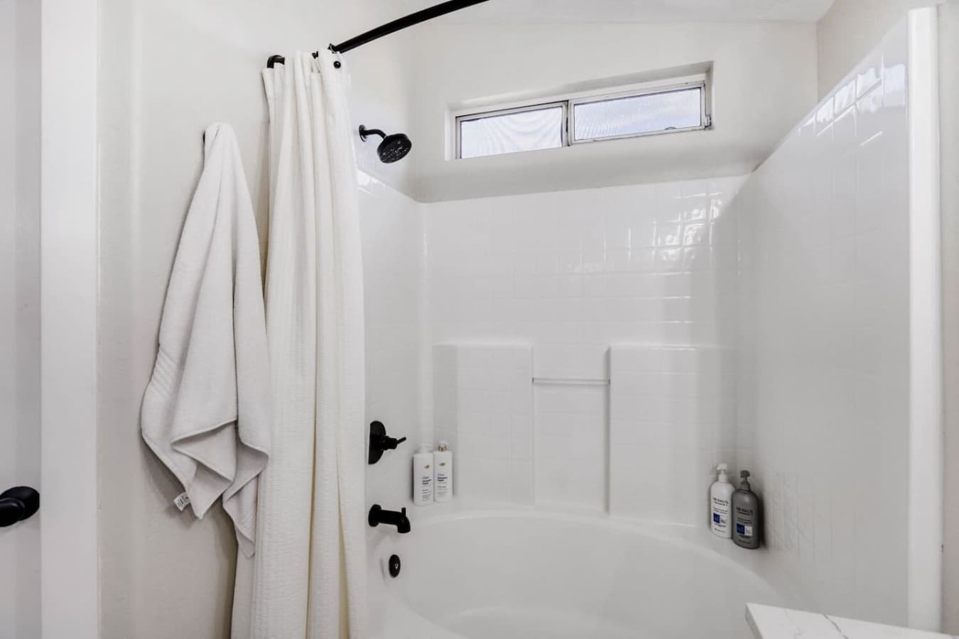 Fresh walk in shower with modern fixtures and crisp white finishes.