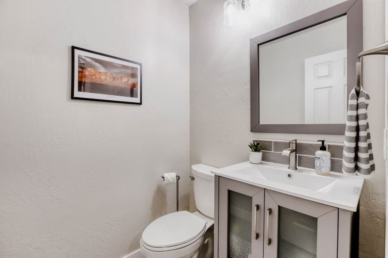 Well appointed bathroom with ample storage and a clean contemporary feel.