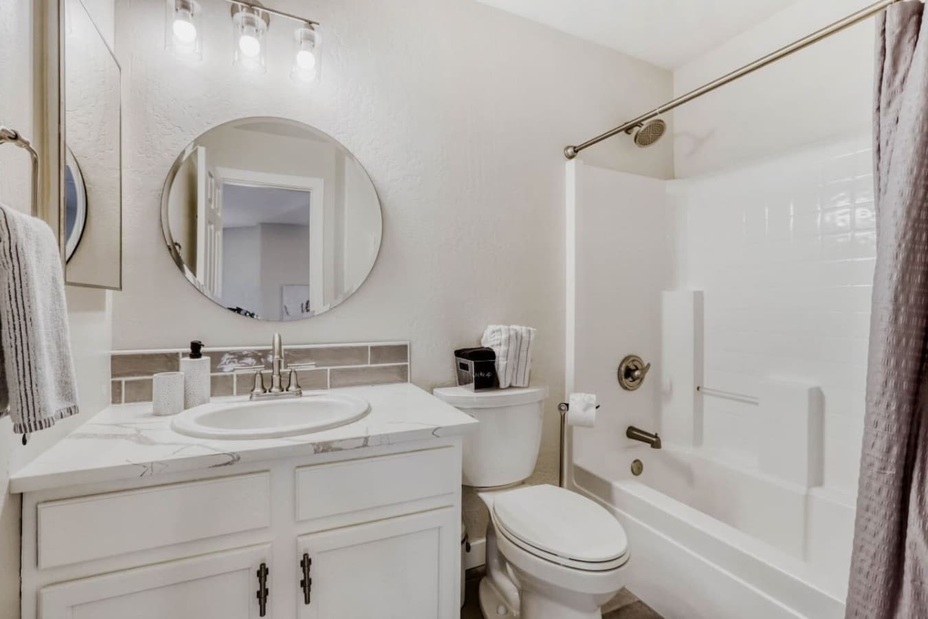 Bright bathroom with a soaking tub and elegant vanity space.