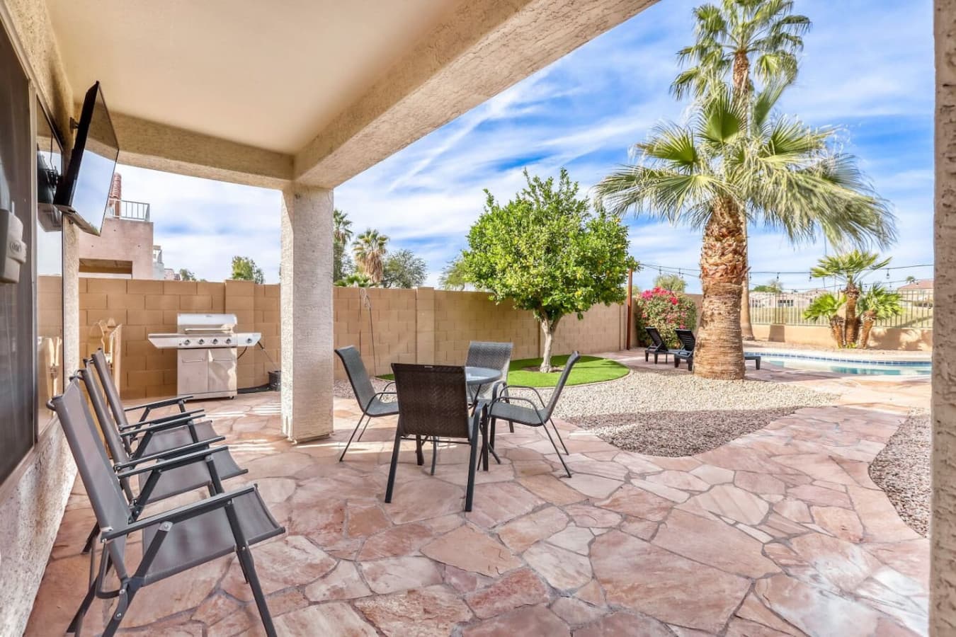 Covered patio with outdoor dining and seating for shaded relaxation.