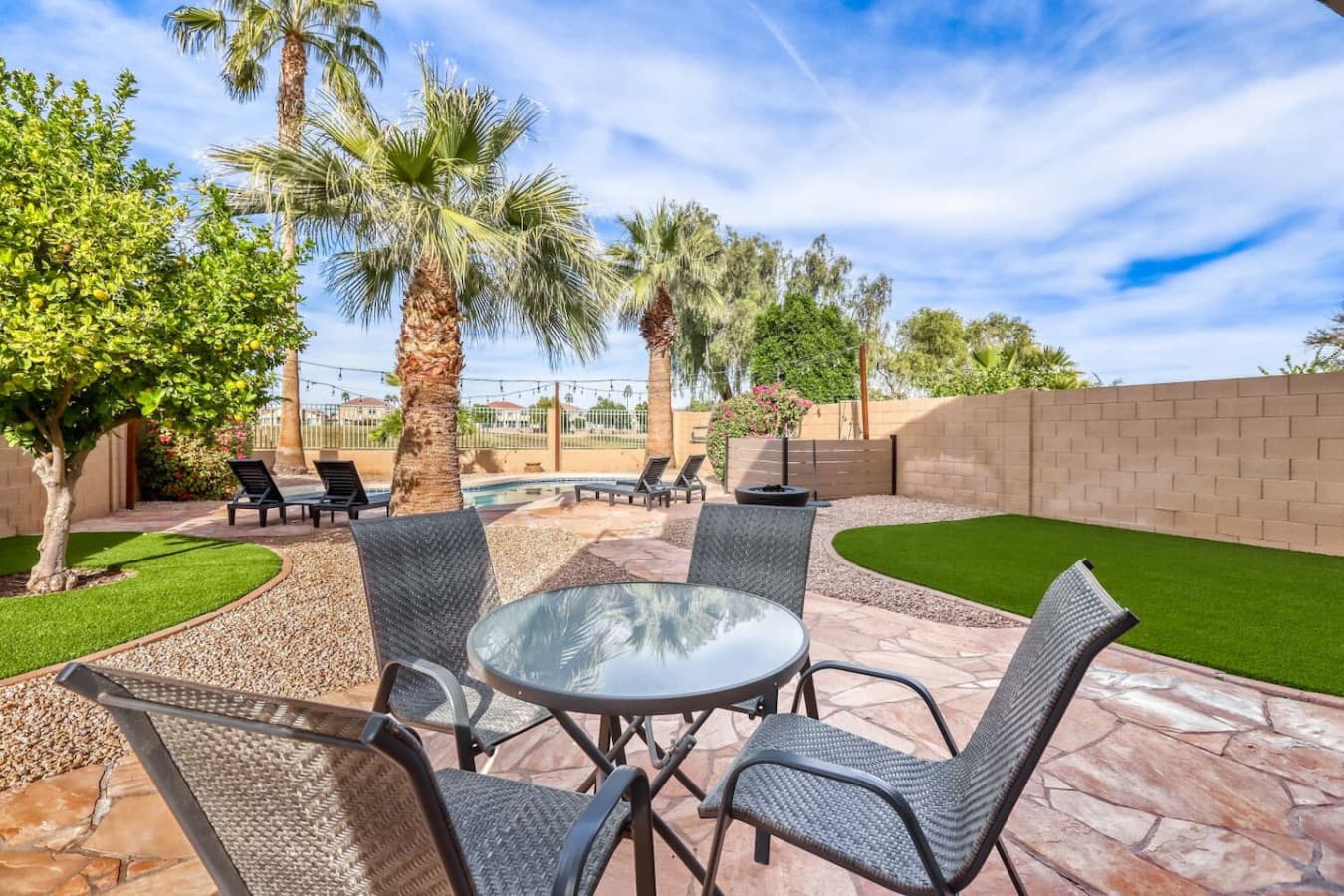 Outdoor dining table set among palms for easy alfresco meals.