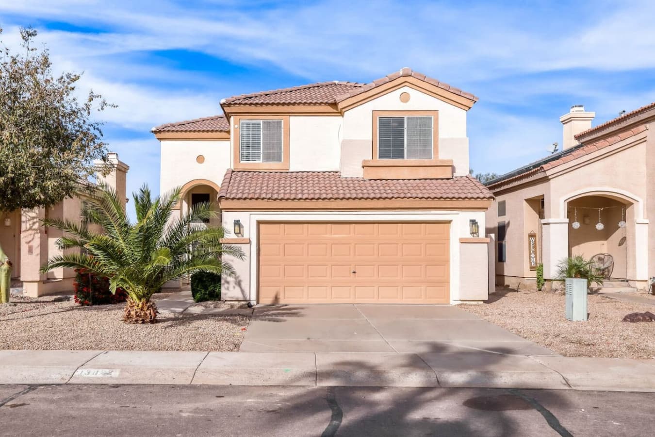 Welcoming front exterior with driveway parking and charming curb appeal.