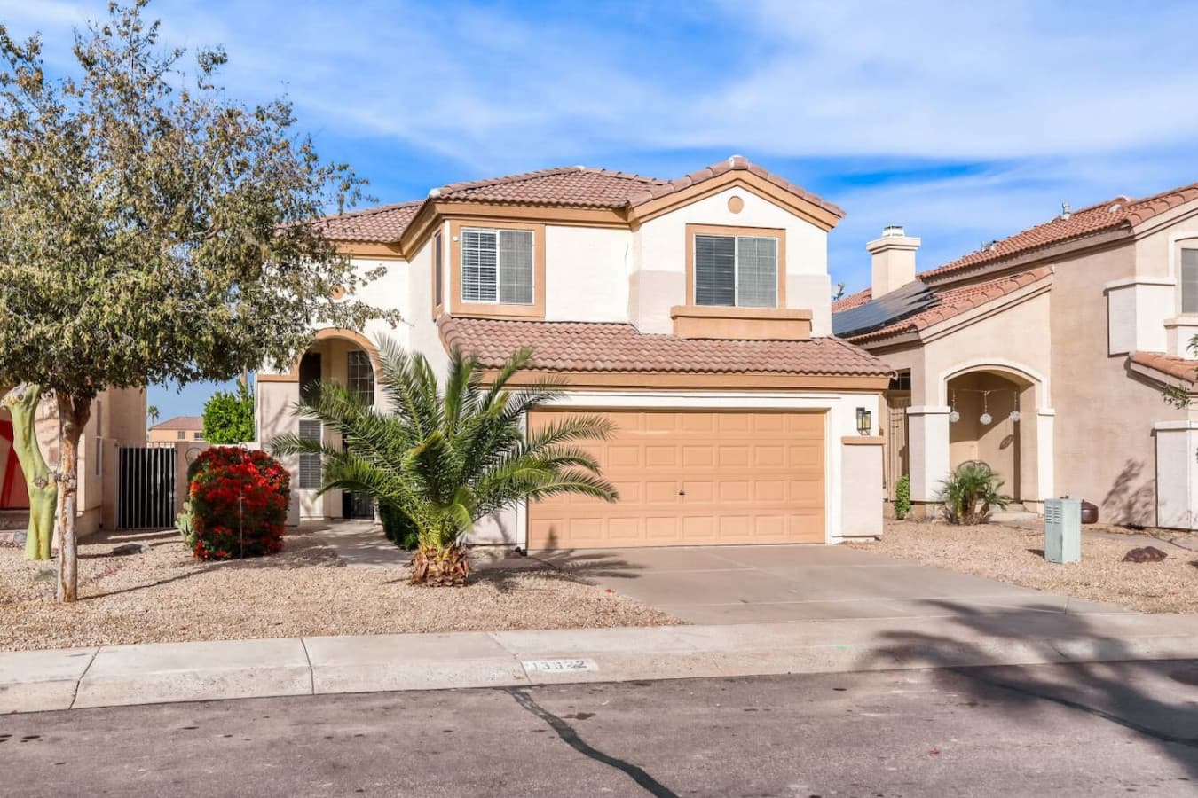 Charming curb appeal with mature palms and a well maintained facade.