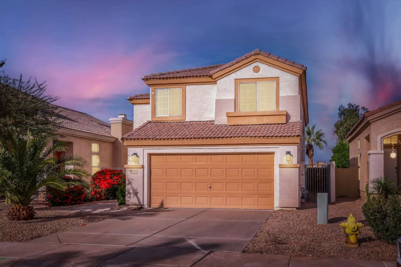 Welcoming exterior with charming curb appeal and a spacious driveway.