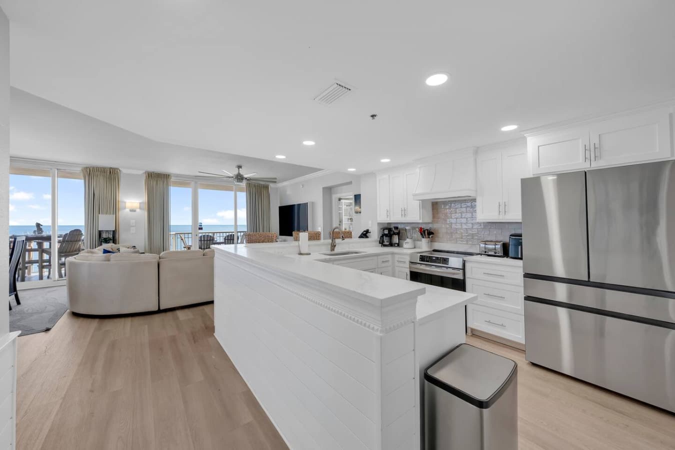 Bright and airy layout connecting kitchen and living area with natural light.