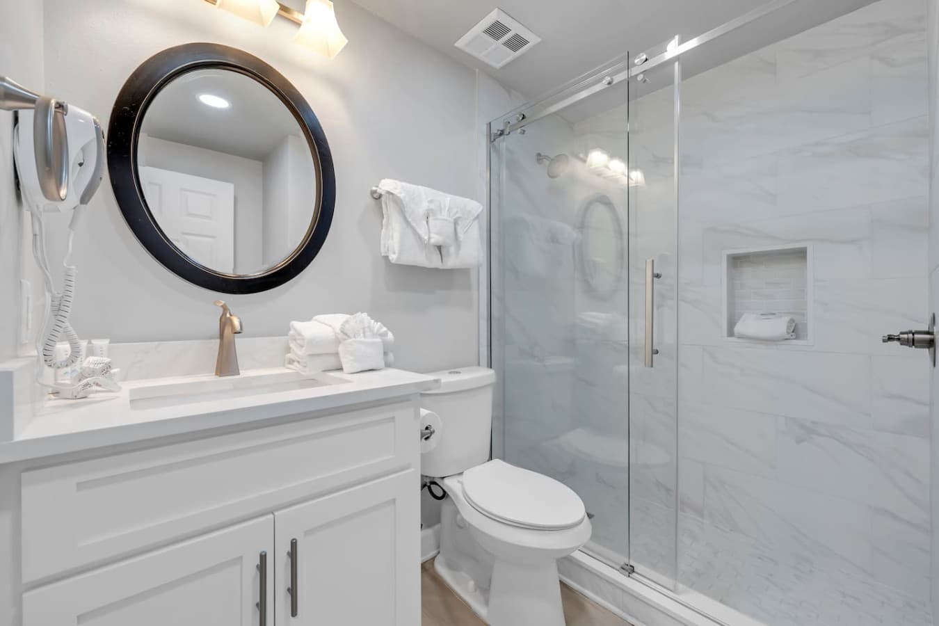 Bright bathroom with glass shower and modern design.