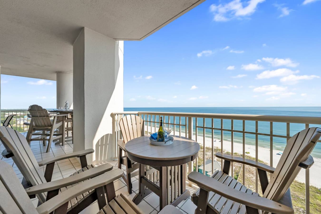 Private balcony with outdoor dining and stunning ocean views.