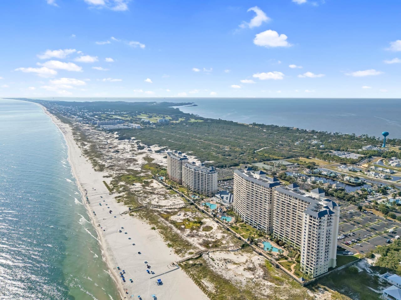 Aerial view of the beautiful beachfront location and surrounding coastline.