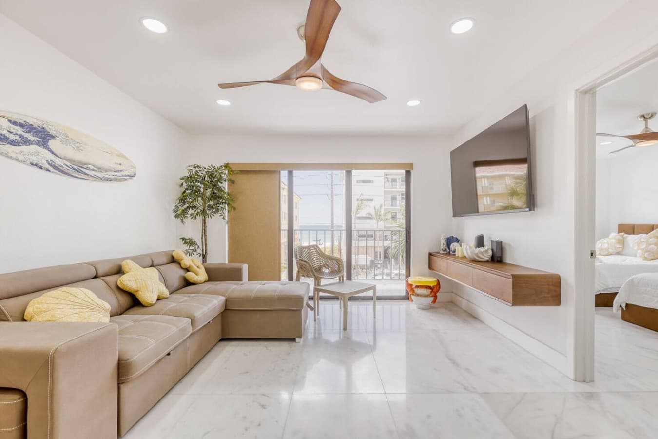 Comfortable living room with natural light and balcony access.