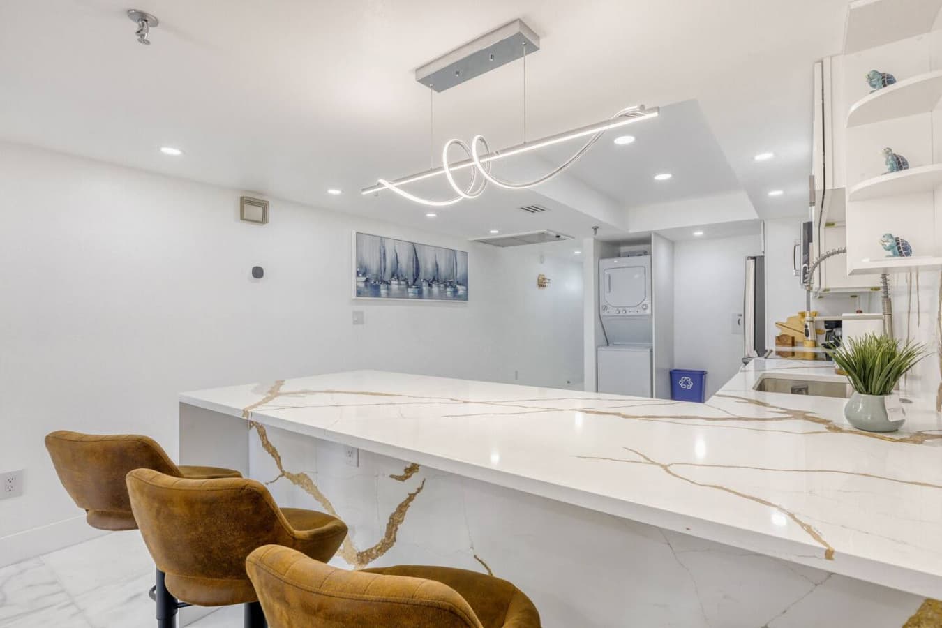 Large waterfall island with seating for casual dining and gathering.