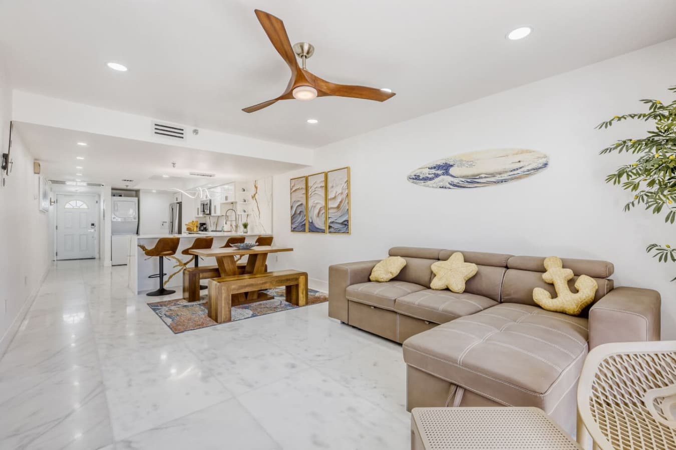 Spacious lounge area connected to dining and kitchen spaces.