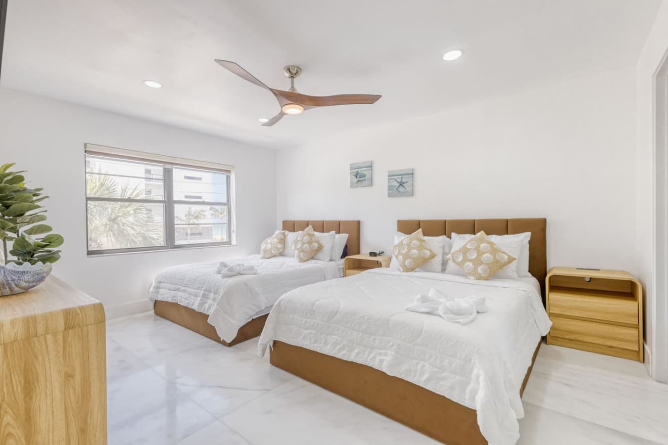 Bedroom with two comfortable beds and soft natural light.