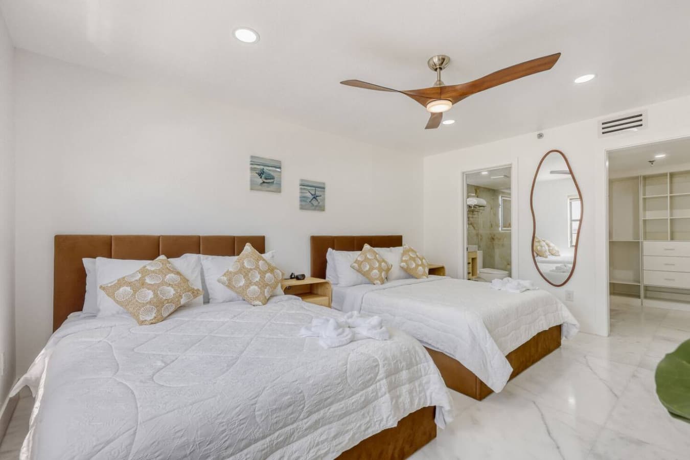 Spacious bedroom with cozy bedding and calming decor.