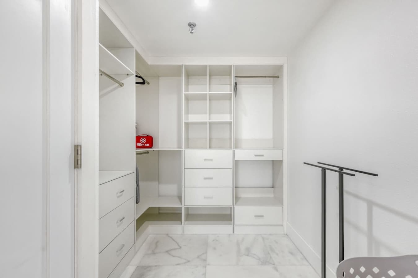 Walk in closet with built in shelving and storage.