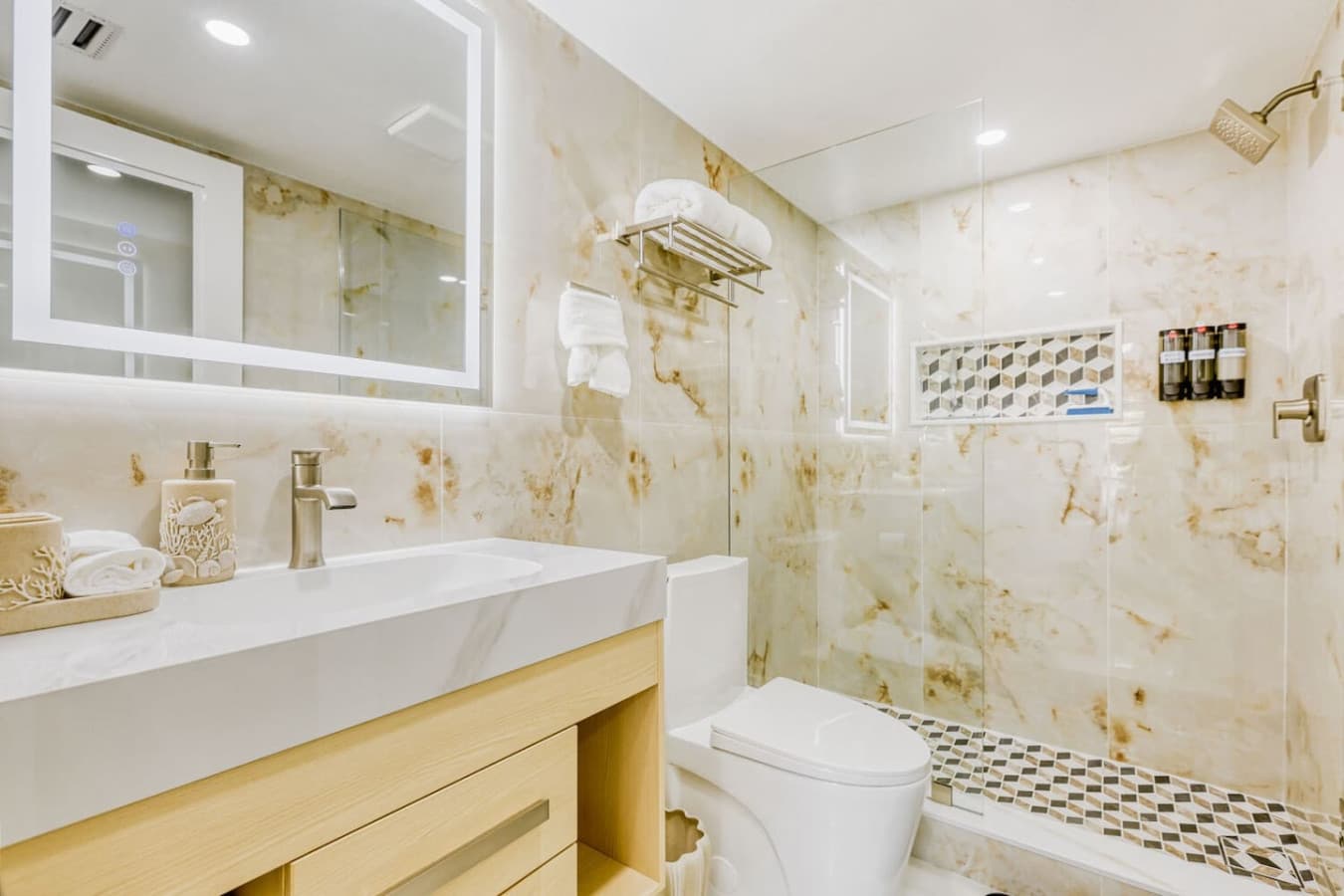 Modern bathroom with updated vanity and tiled walk in shower.