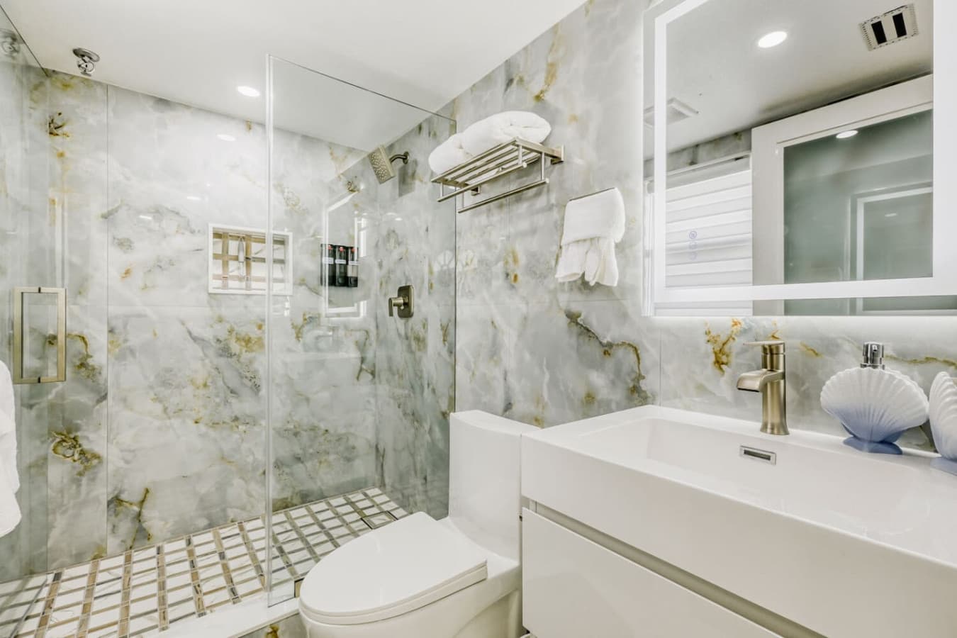 Modern bathroom with walk in shower and updated finishes.