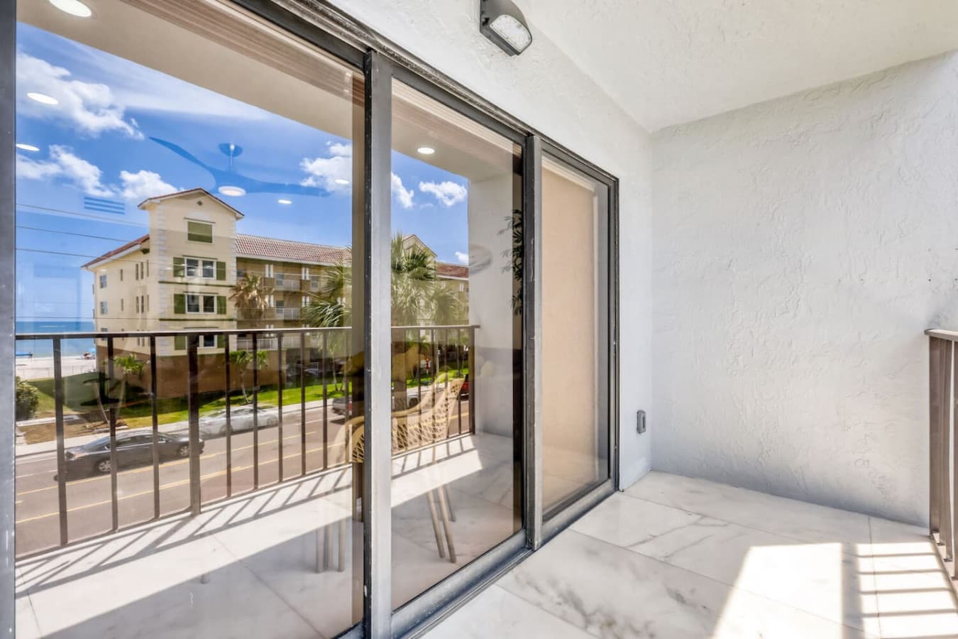 Sliding glass doors leading to outdoor balcony space.