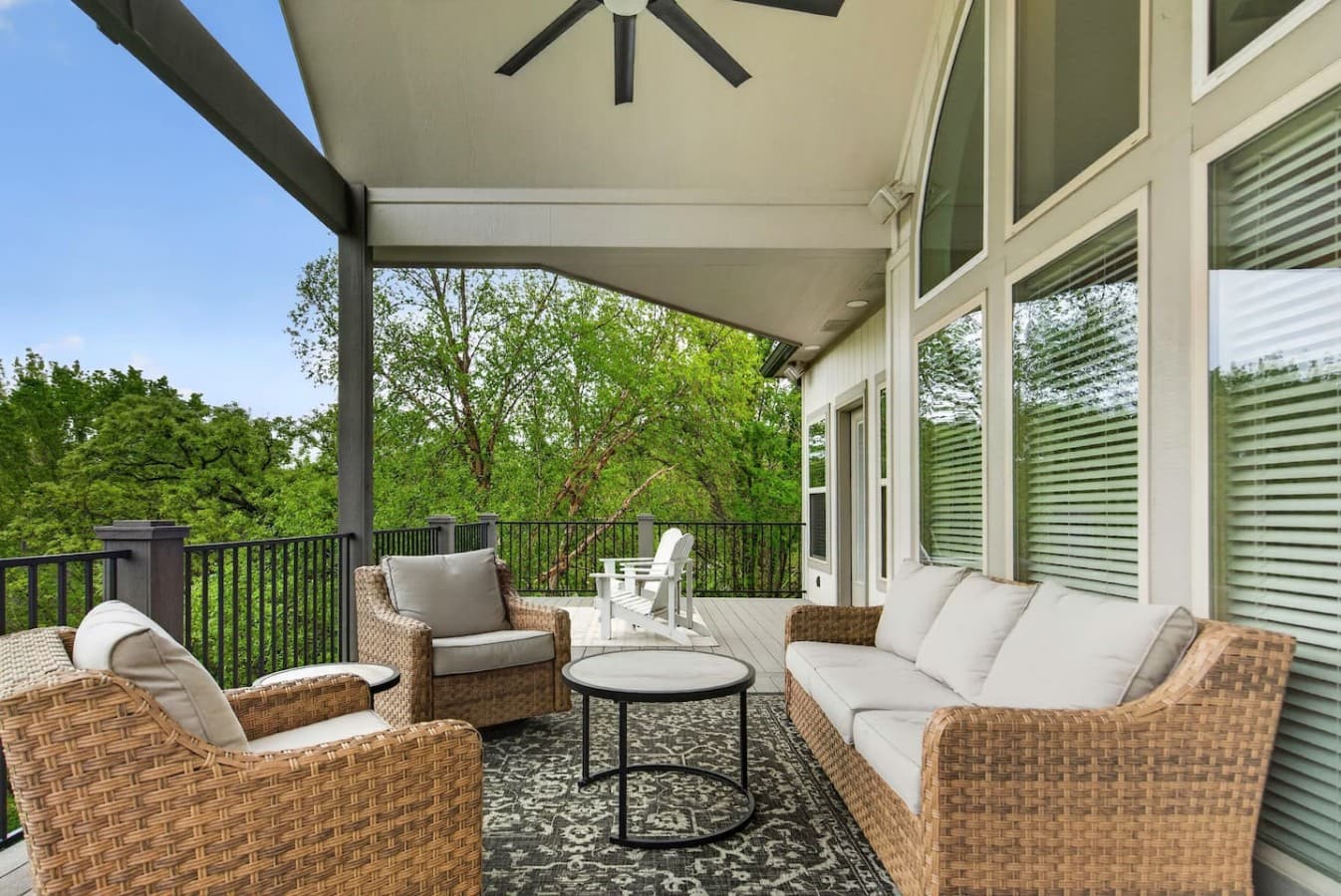 Inviting outdoor sitting area overlooking the trees with comfortable seating and a calm private atmosphere.