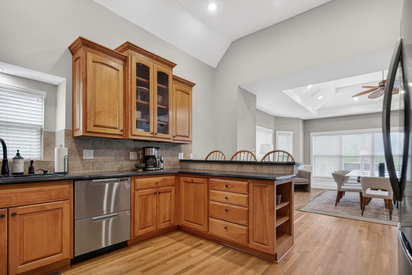 Open concept kitchen with expansive counters, natural wood finishes, and seamless flow into the living room.