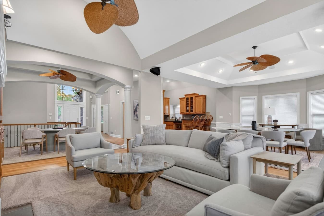 Bright open concept living room with soaring ceilings and abundant natural light.