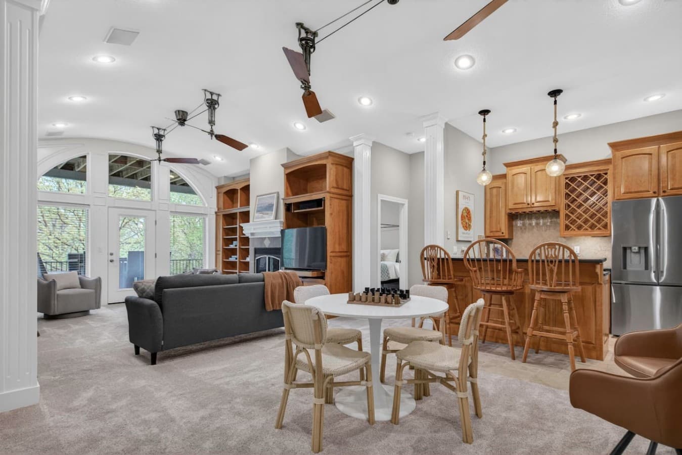 Spacious main living area with cozy seating, built in entertainment center, and open kitchen access.