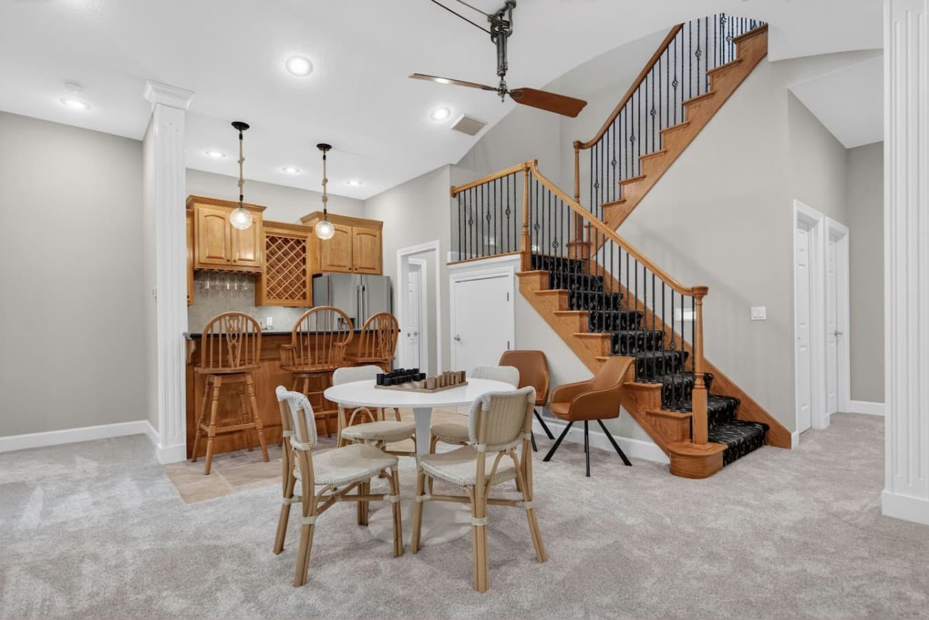 Open dining space with high ceilings and staircase views connecting the heart of the home.