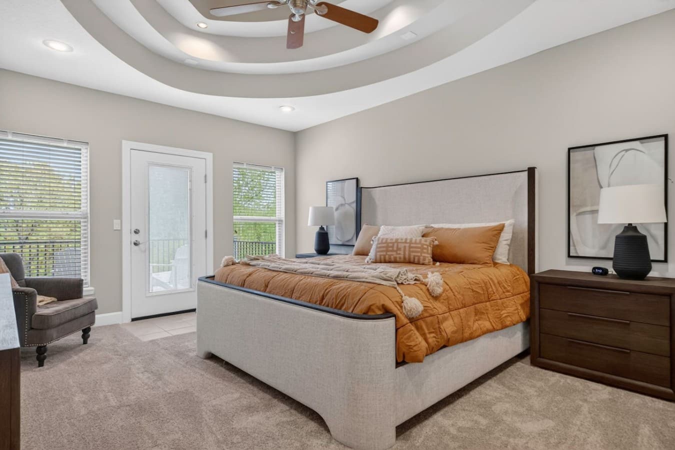 Bright and relaxing bedroom retreat with private outdoor access and elegant layered ceiling details.