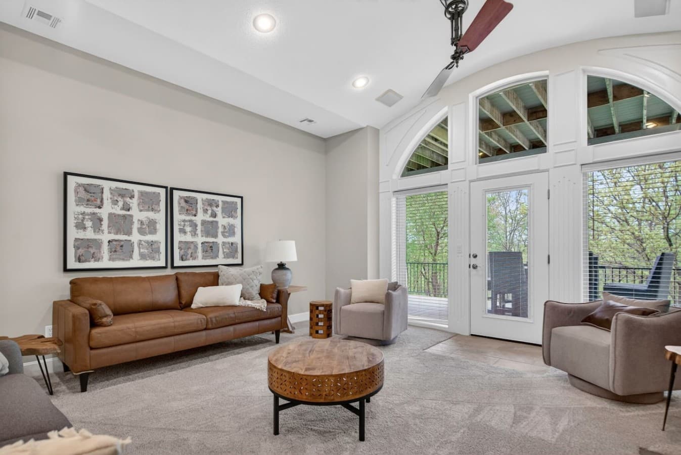Light filled sitting area with soaring windows and cozy seating designed for quiet mornings or evening conversations.