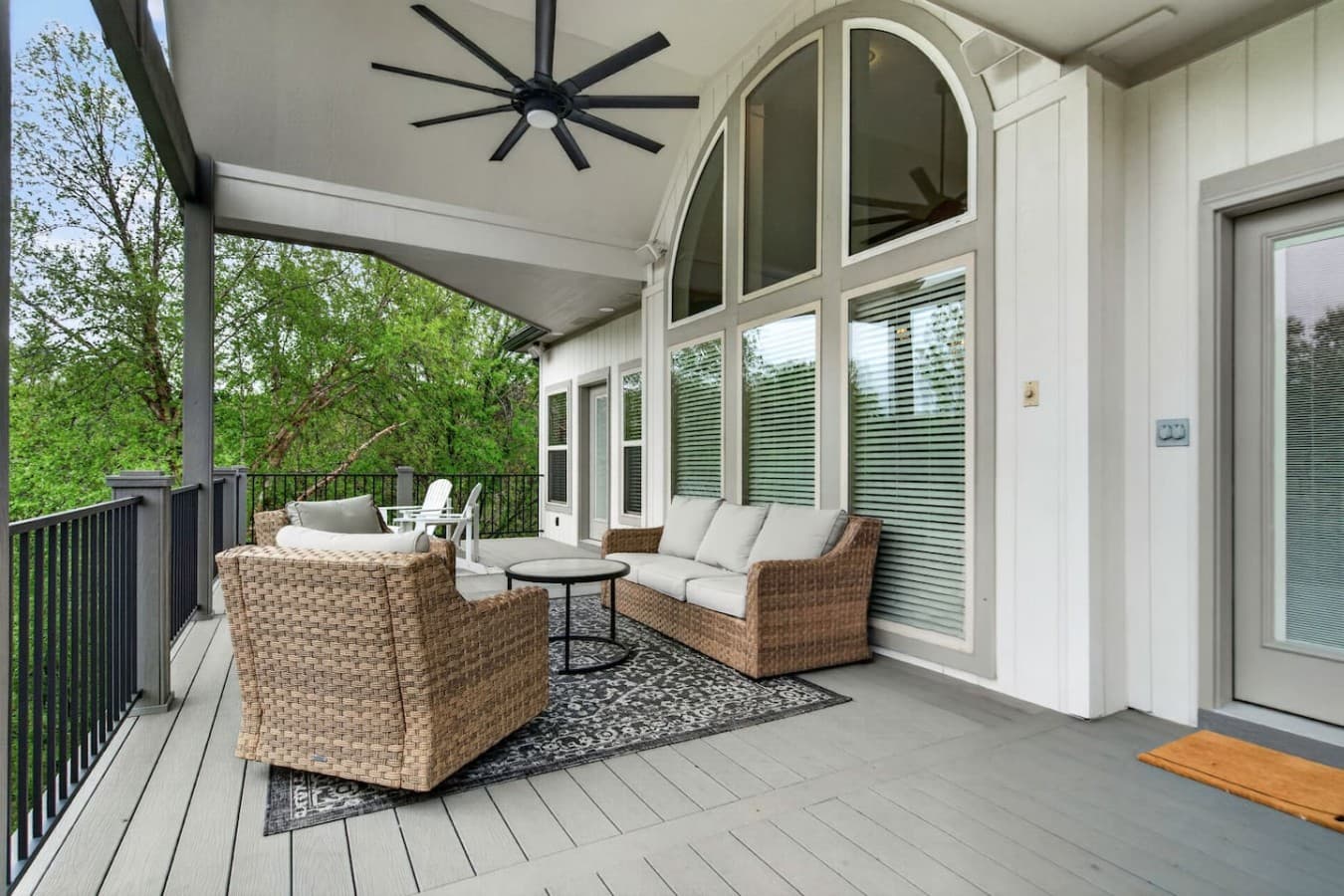 Comfortable outdoor lounge area with soaring windows and cozy seating perfect for relaxing evenings.