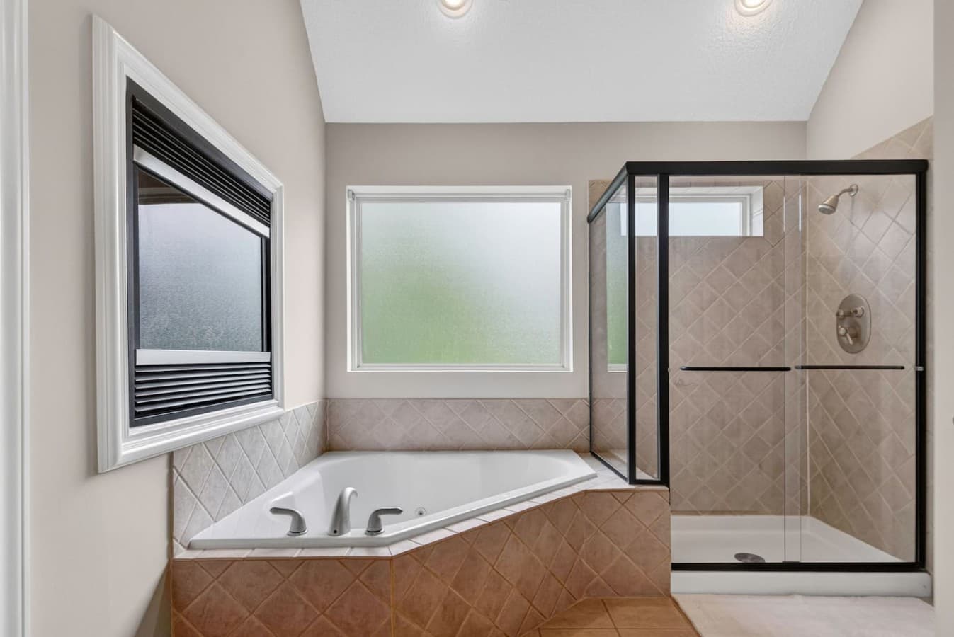 Spa inspired bathroom with soaking tub, walk in shower, and peaceful window views.
