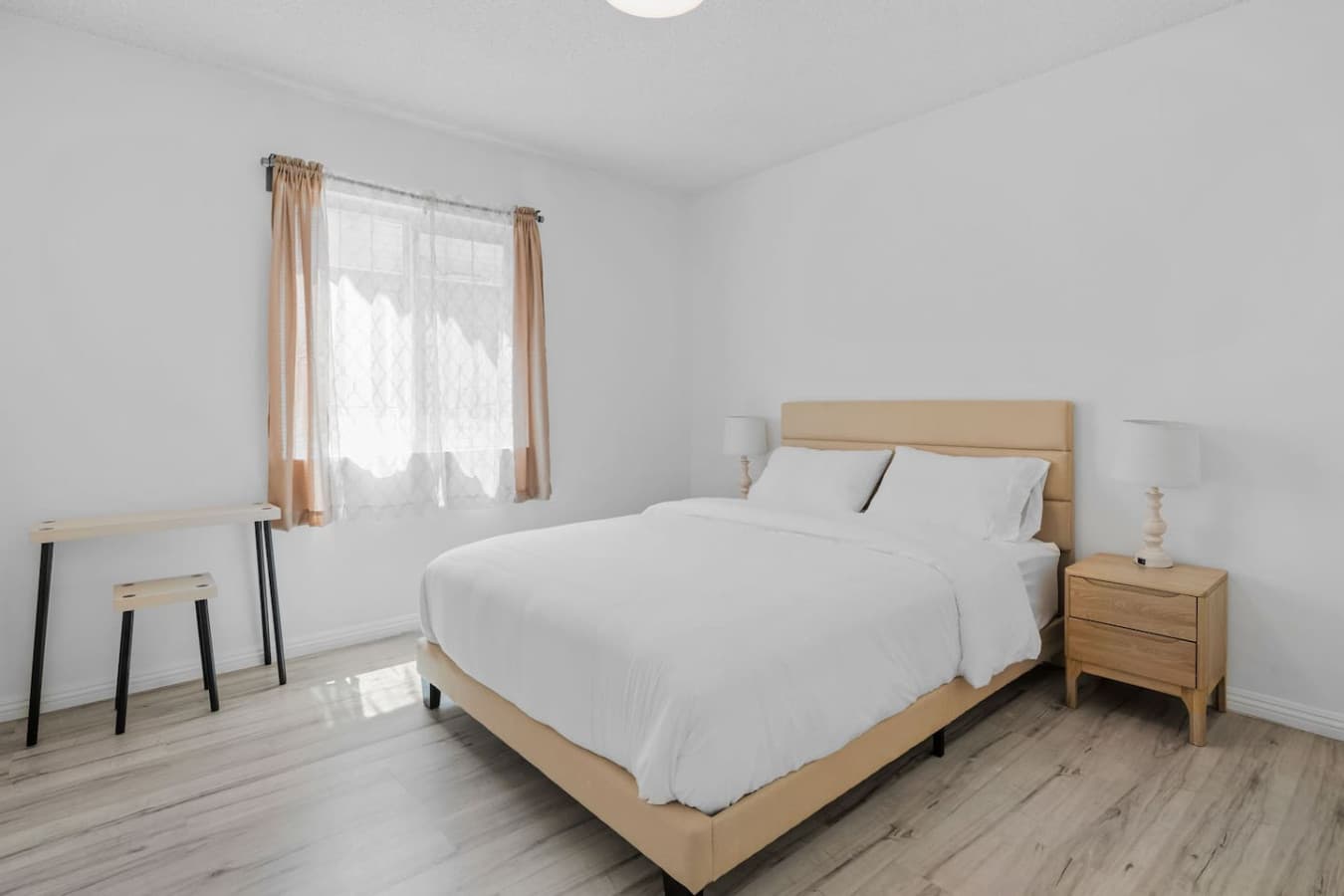 Second bedroom features queen size bed and dedicated workspace.
