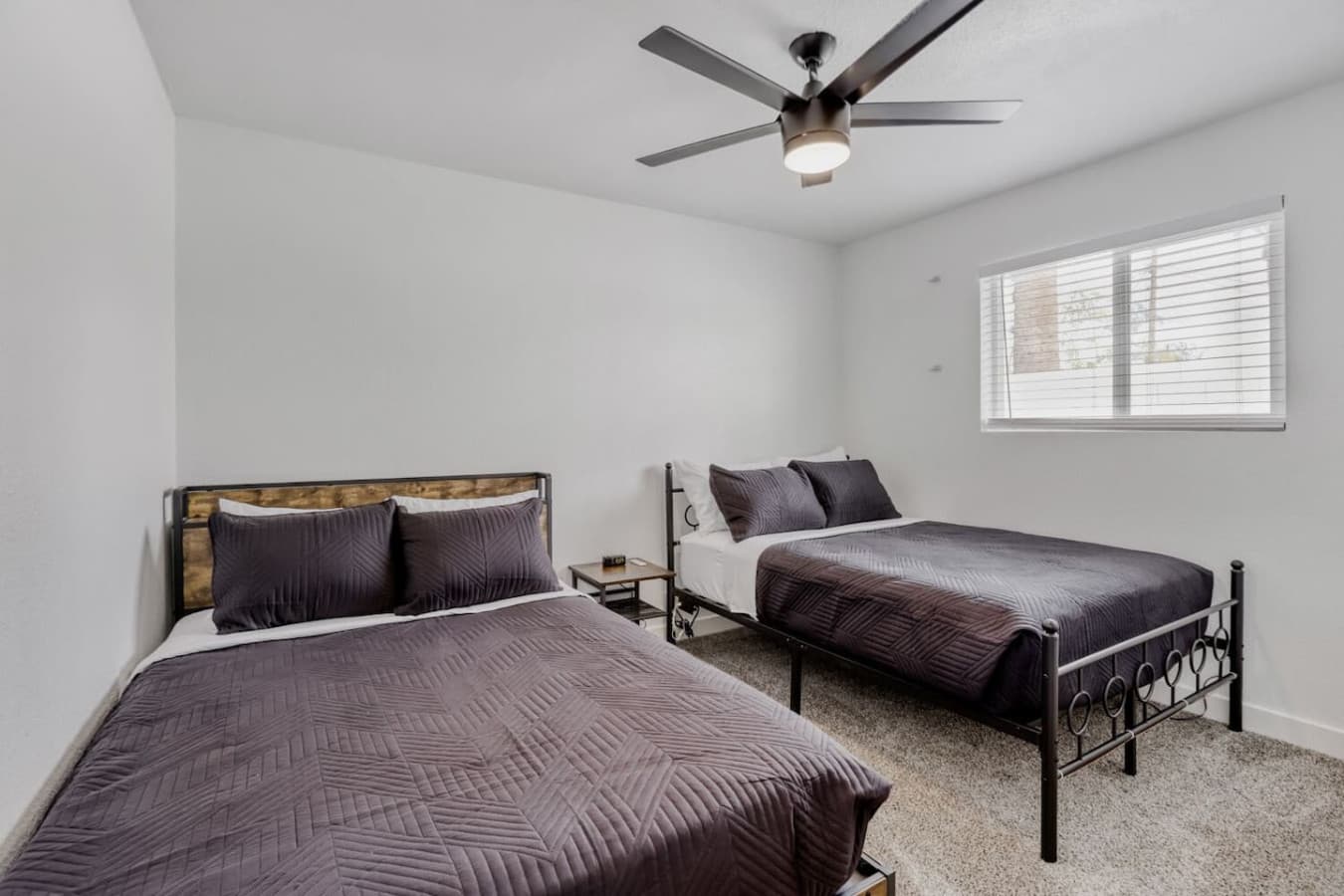 Bedroom with two beds and cozy setup.
