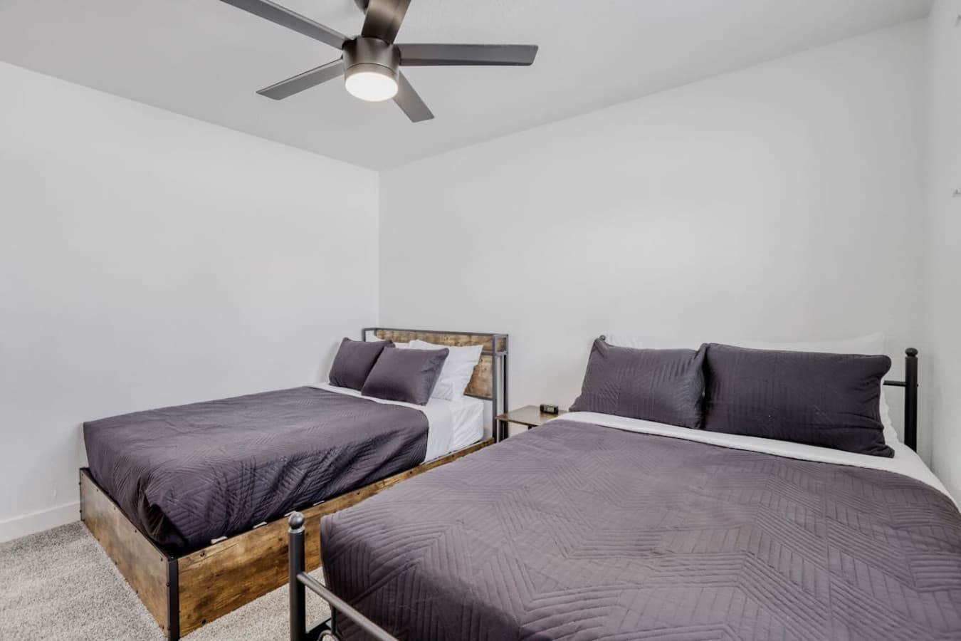 Another bedroom with dual beds and clean layout.