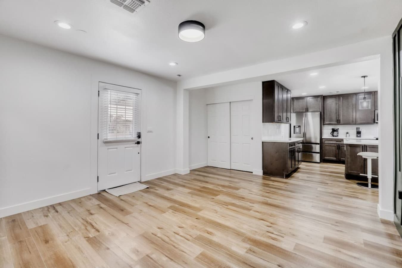 Open living area with modern flooring and bright layout.