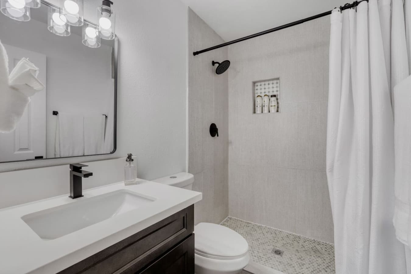 Walk in shower bathroom with modern fixtures.