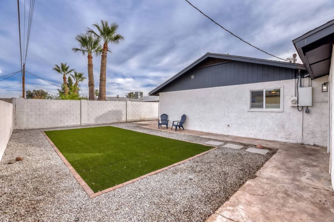 Private backyard with turf and seating.