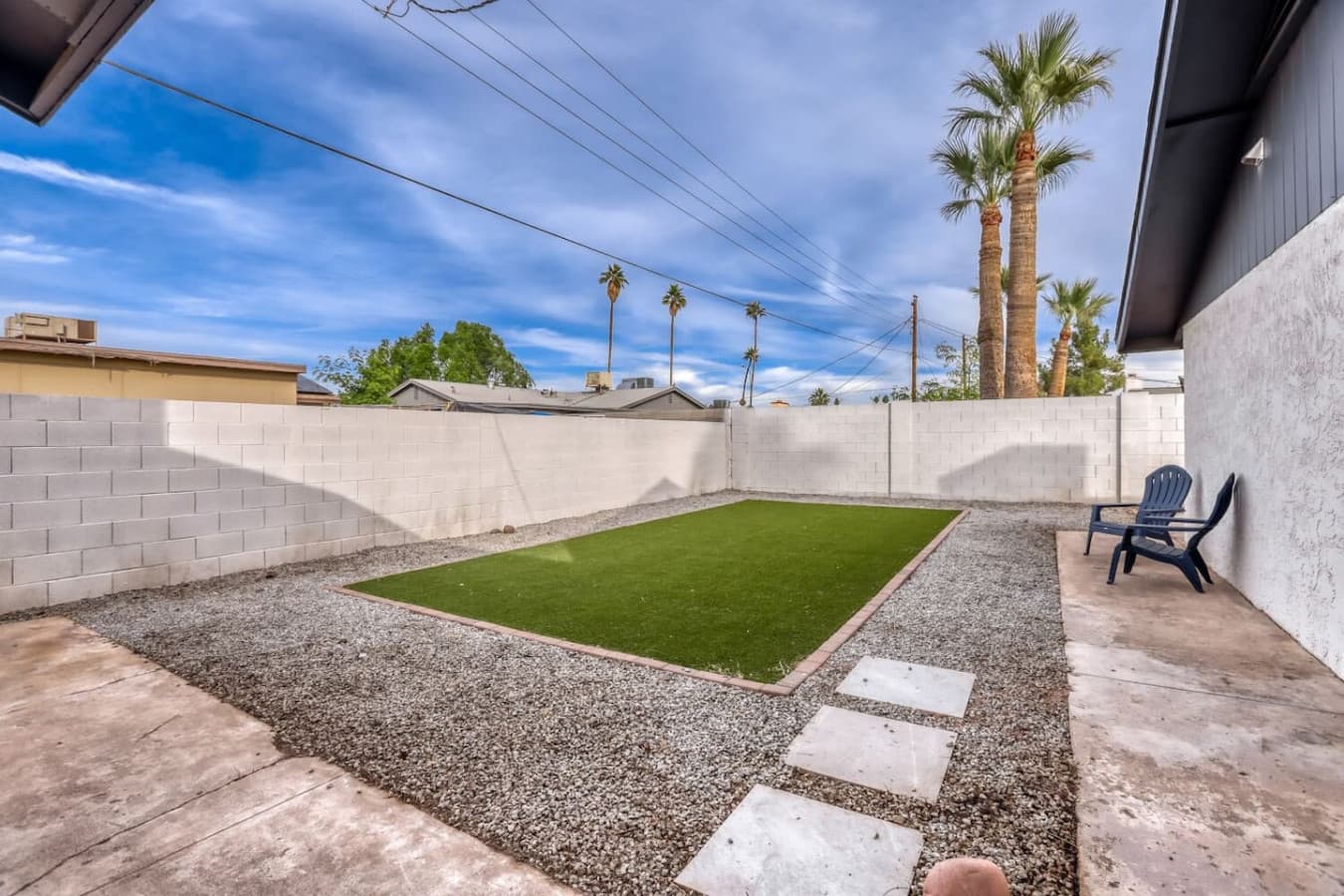 Private backyard with turf and gravel paths.