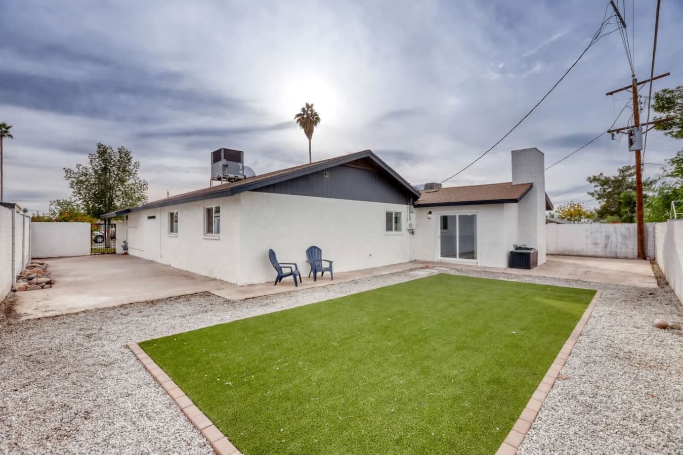 Backyard view with seating and green lawn.