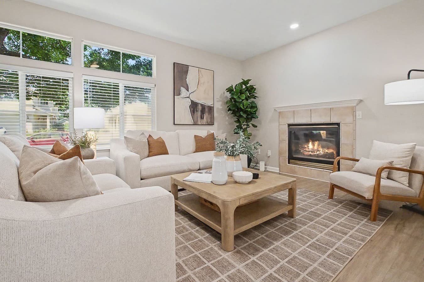 Bright and airy living room with comfortable seating and a cozy fireplace centerpiece.