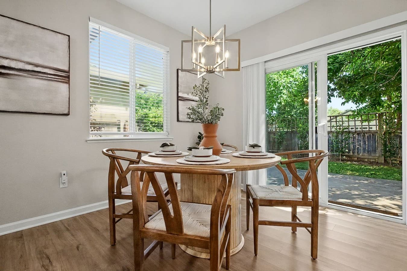 Sun filled dining area with peaceful backyard views and natural light throughout.