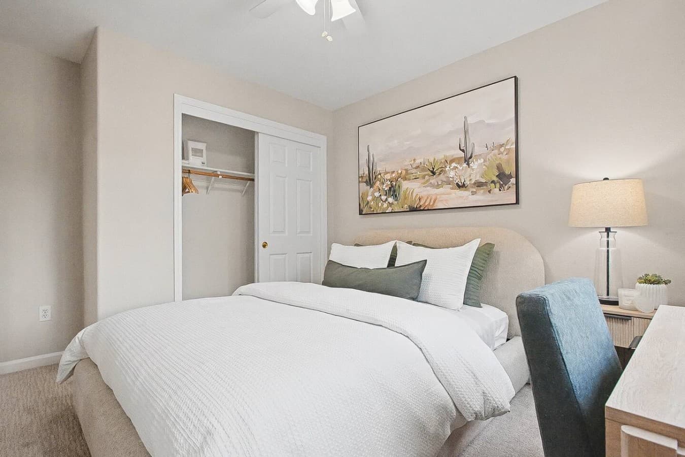Peaceful bedroom with soft linens, neutral tones, and a comfortable sleeping setup.