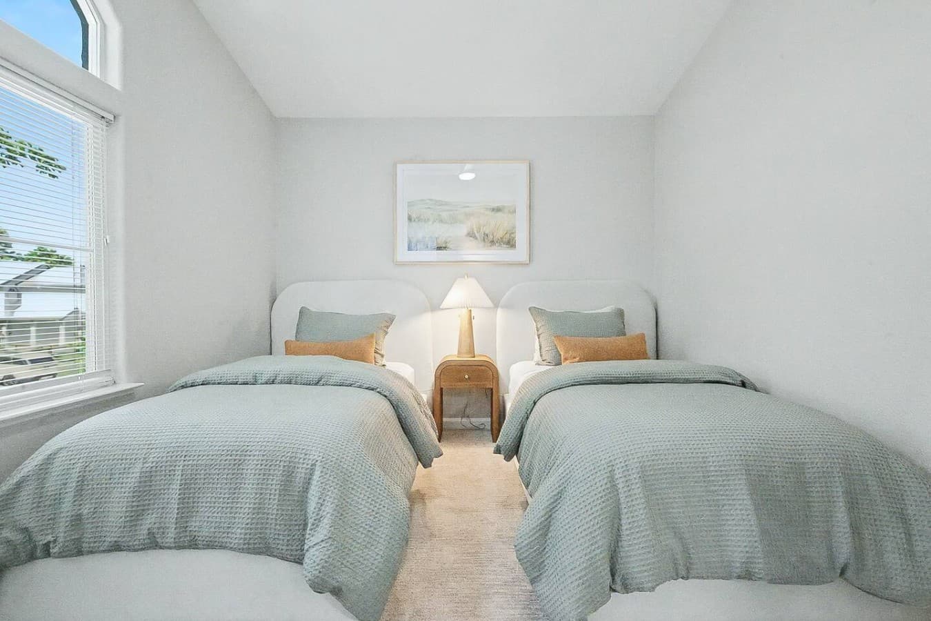 Bright guest bedroom with two twin beds perfect for families or friends traveling together.