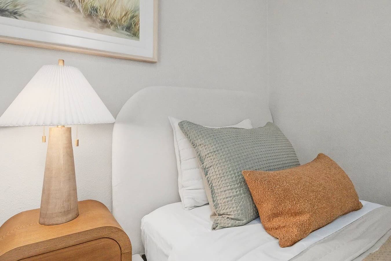 Thoughtfully styled twin bedroom with soft textures and cozy accents.