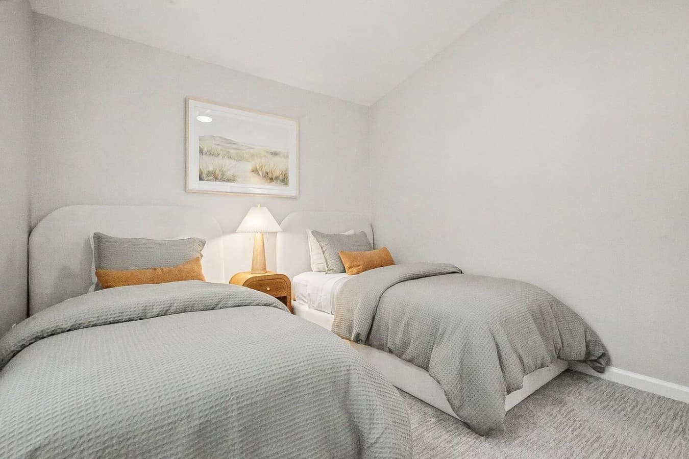 Inviting guest room with plush bedding and a clean minimalist design.