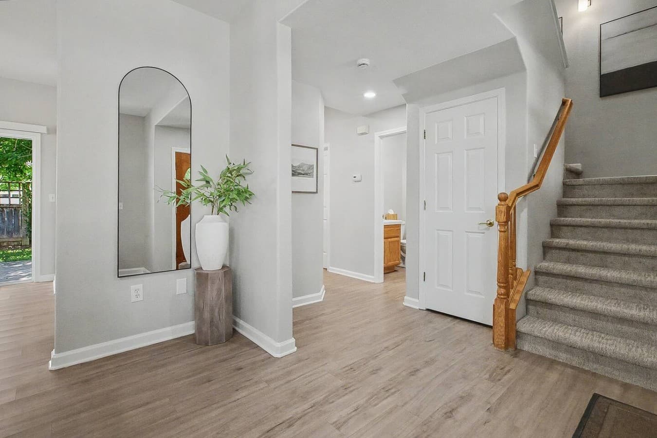 Bright entryway with open space, modern flooring, and welcoming natural light.